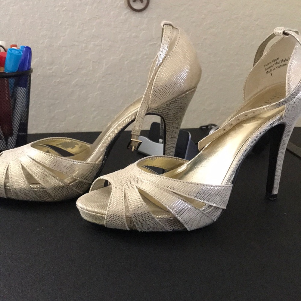 Gold high heeled shoes